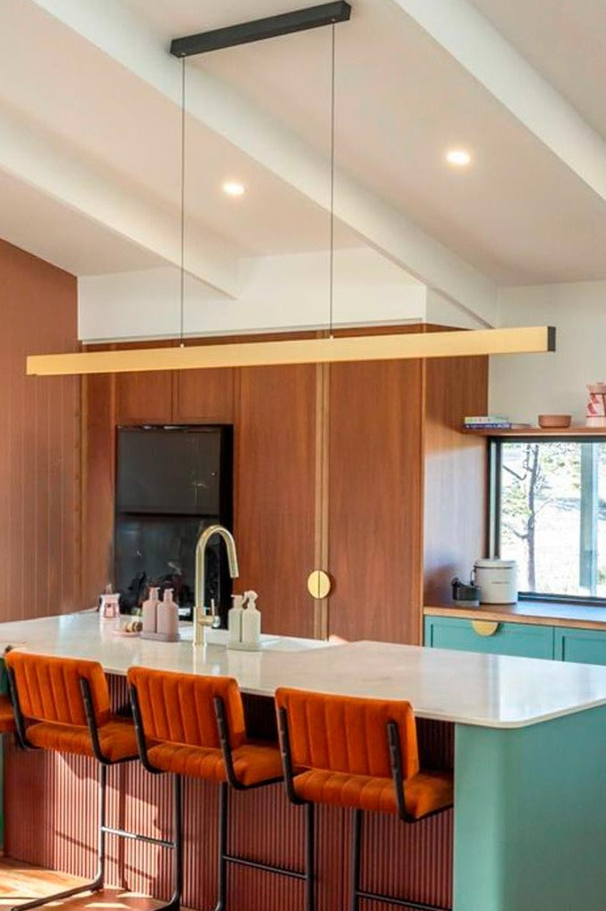 Gold LED pendant light over kitchen island
