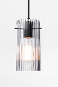 Indiana Glass Pendant Light featuring reeded clear glass and black pendant cord.