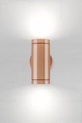 Solid copper up/down wall spot light with a polished finish.
