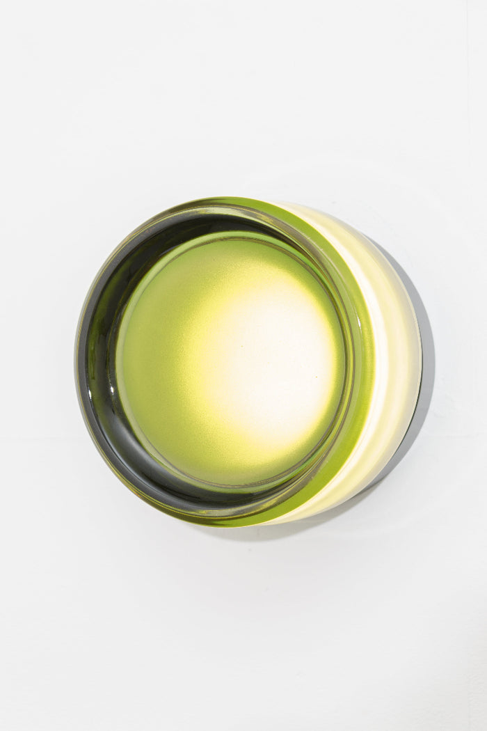 Green LED wall light shown side-on with light illuminated.