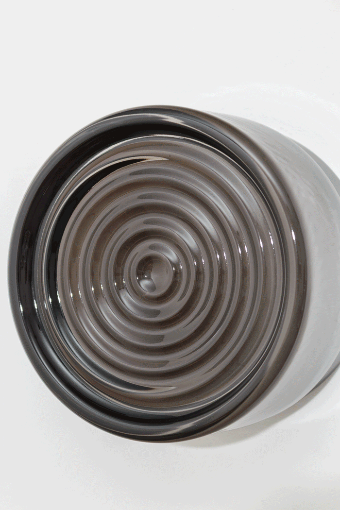 Close-up GIF of the grey LED glass wall light highlighting the smoked ribbed glass texture and circular detailing when on and off.