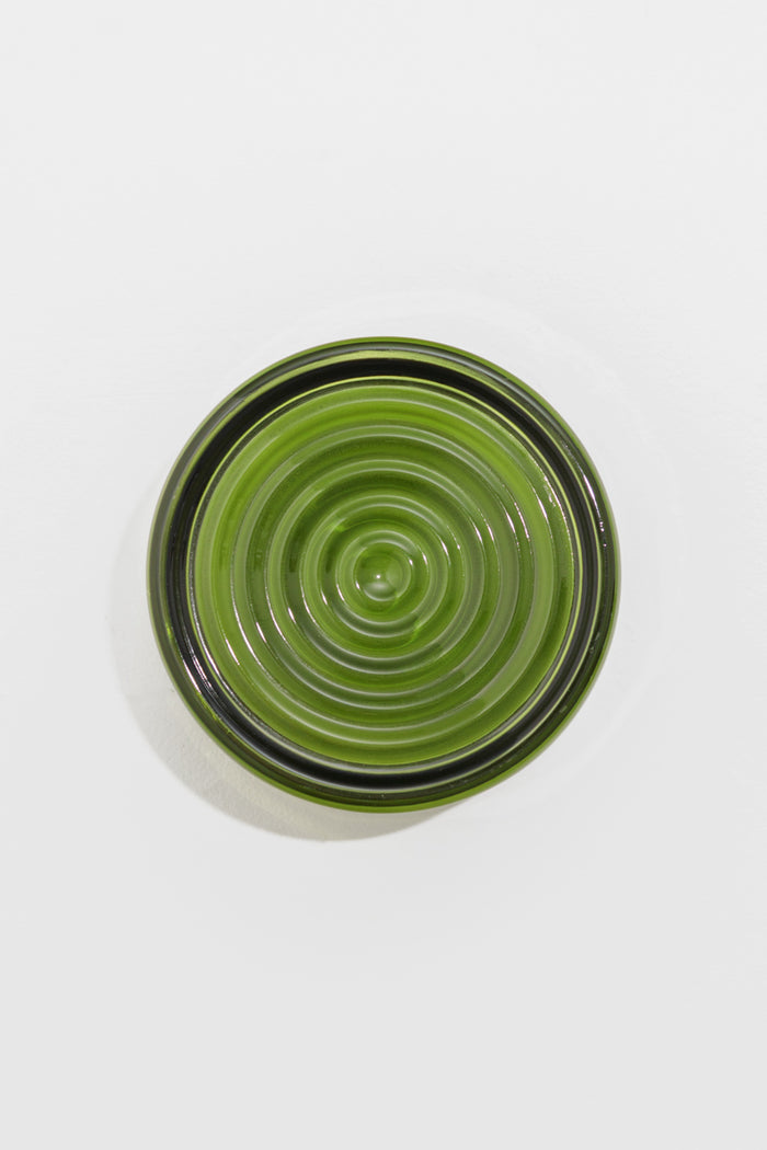 View of the green LED glass wall light with detailed concentric ribbed glass finish.