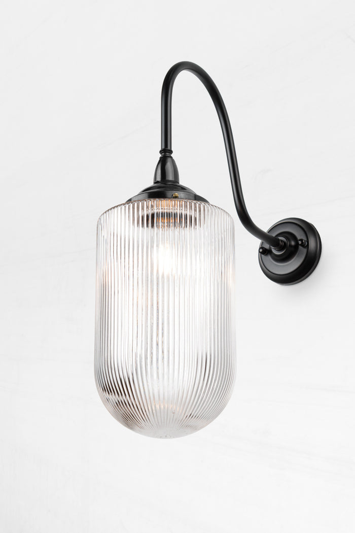 Large clear reeded glass shade on a black extra large gooseneck  outdoor wall light.