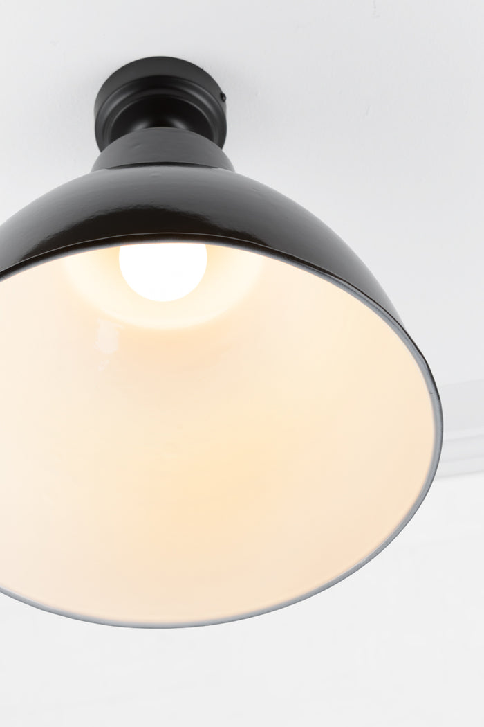 Close up of the large steel shade finished in black, showing the white inner.