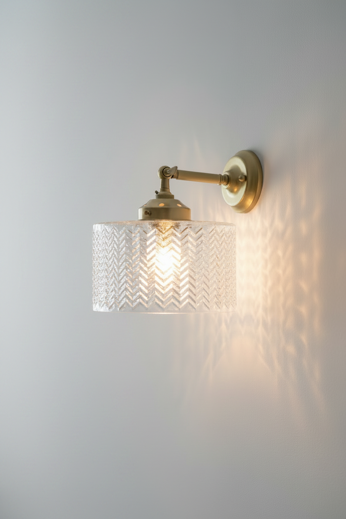 Malibu Glass Swivel Wall Light in solid gold/brass with a clear textured glass shade.