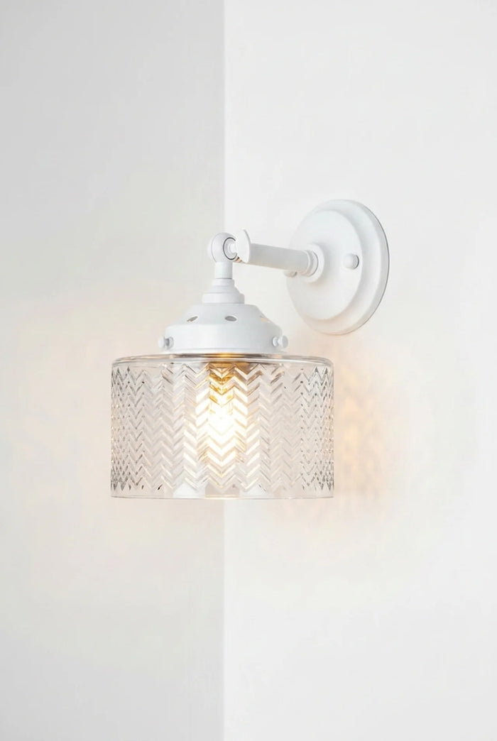 Malibu Glass Swivel Wall Light with a short white arm and  a clear textured glass shade.