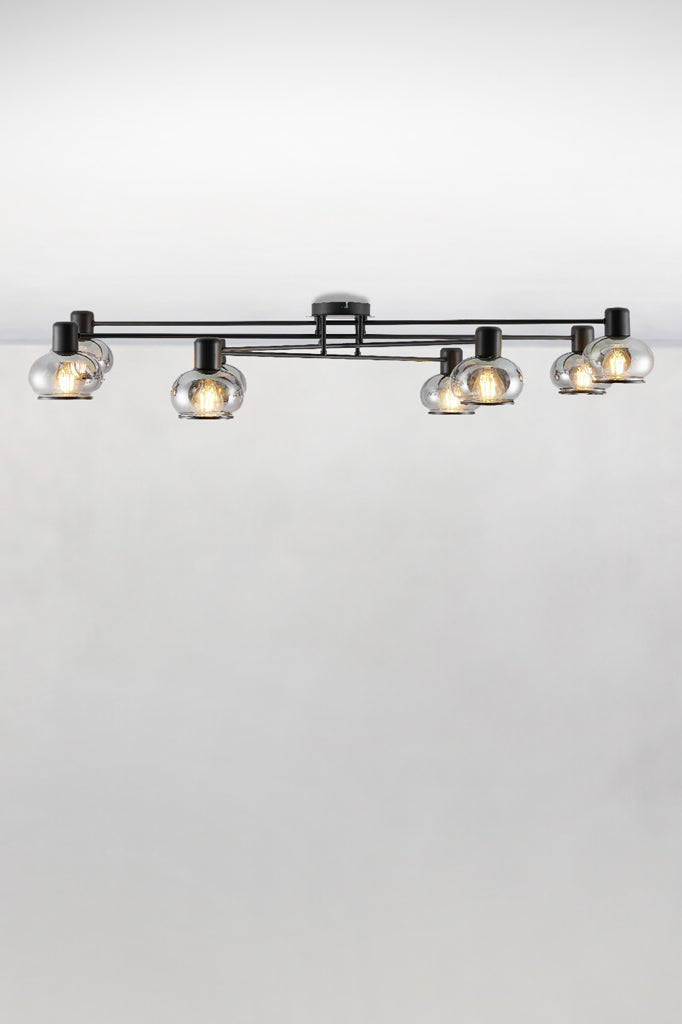 Side view of the 8 light ceiling light in black with glass shades
