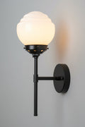 Side view of the opal glass shade on the black stem wall sonce