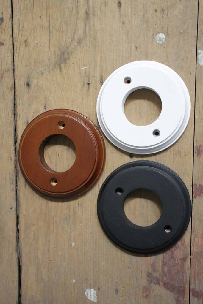 Wooden mounting blocks in brown, white, and black finishes.
