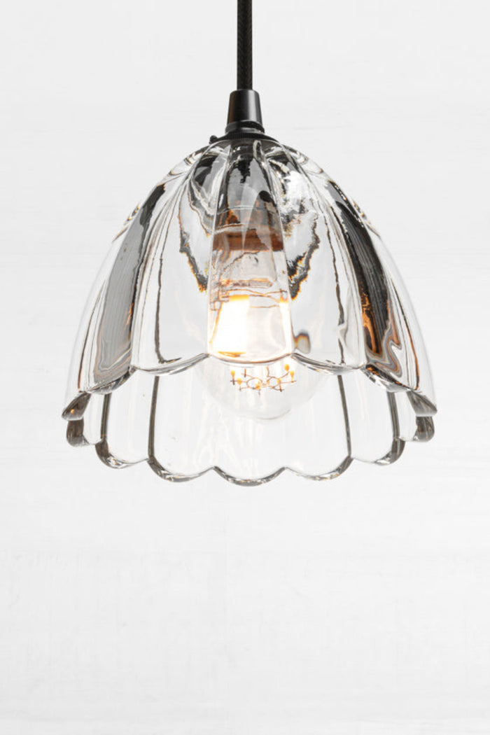 Monroe Glass Pendant with clear textured glass shade and black cord suspension.