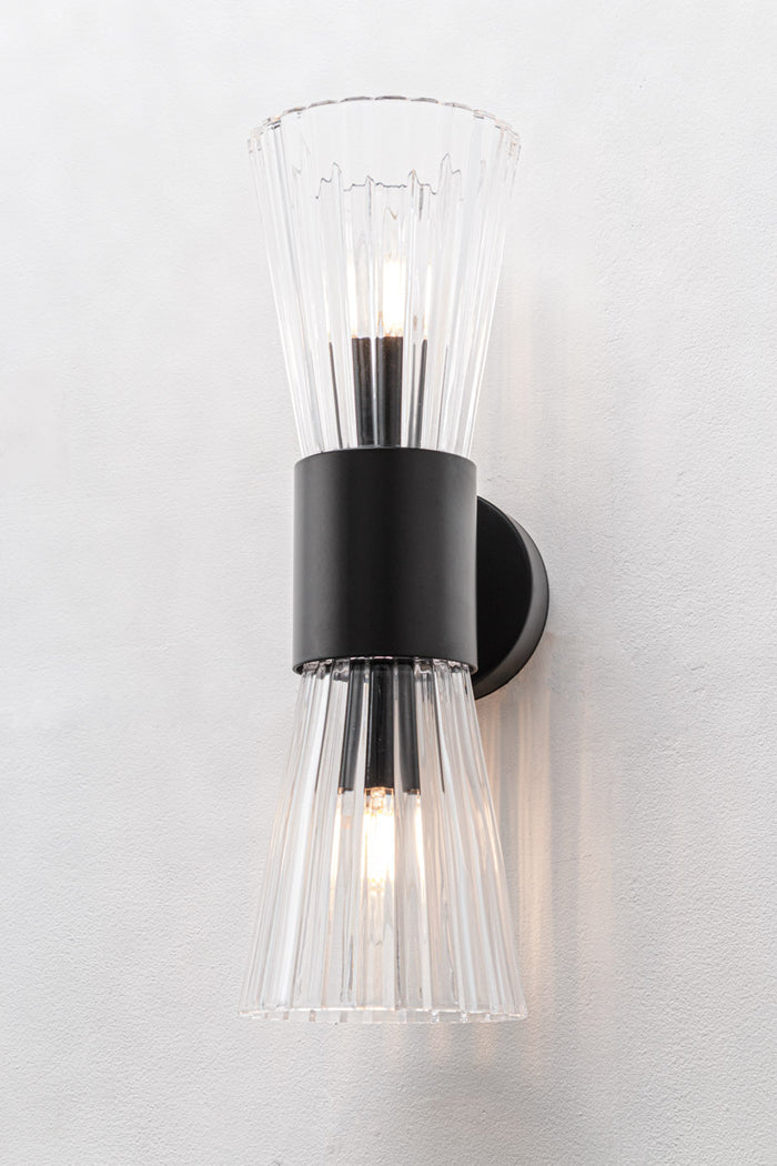 Hourglass silhouette with two open-ended fluted glass cones facing up and down with black fitting finish
