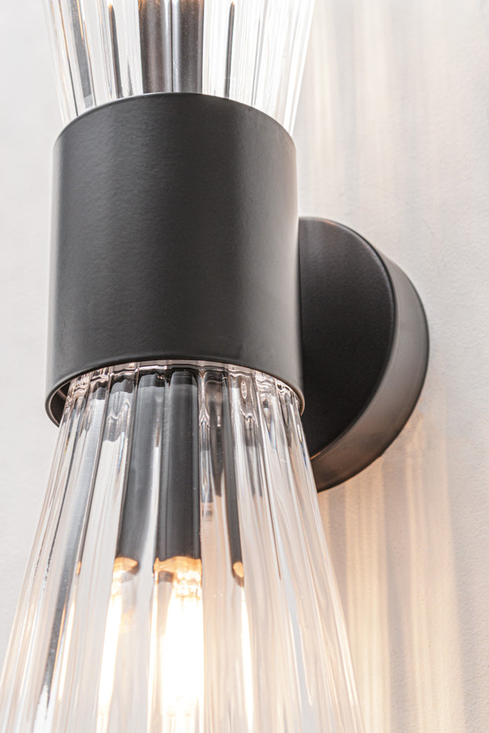 pair of clear ribbed glass shades and sculptural steel body.