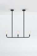 Triple lamp linear chandelier in black.