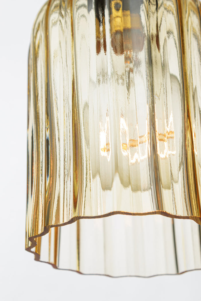 Close up of the amber glass shade, showcasing the fluted detailing.