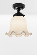 Opal frill edged shade on a black batten holder.