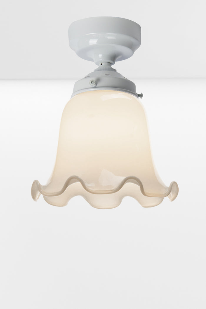Opal frill edged shade on a white batten holder.