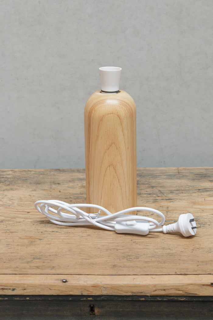 Scandinavian curved wood block table lamp with white cord anf lampholder.