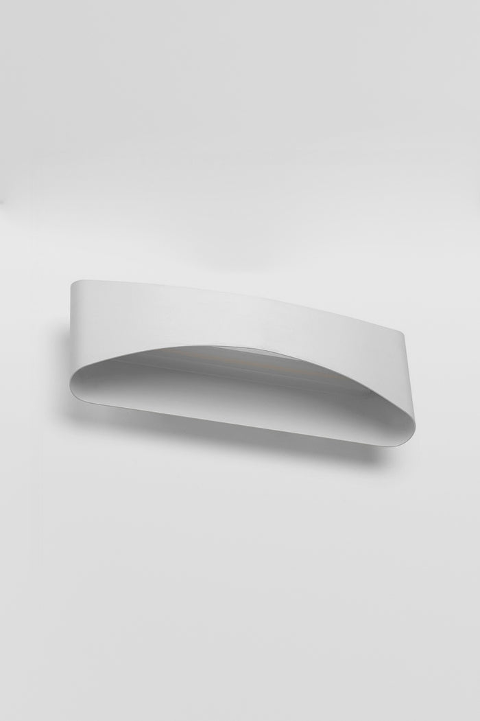 Under view of the Up/Down wall light in a white finish with the light on.