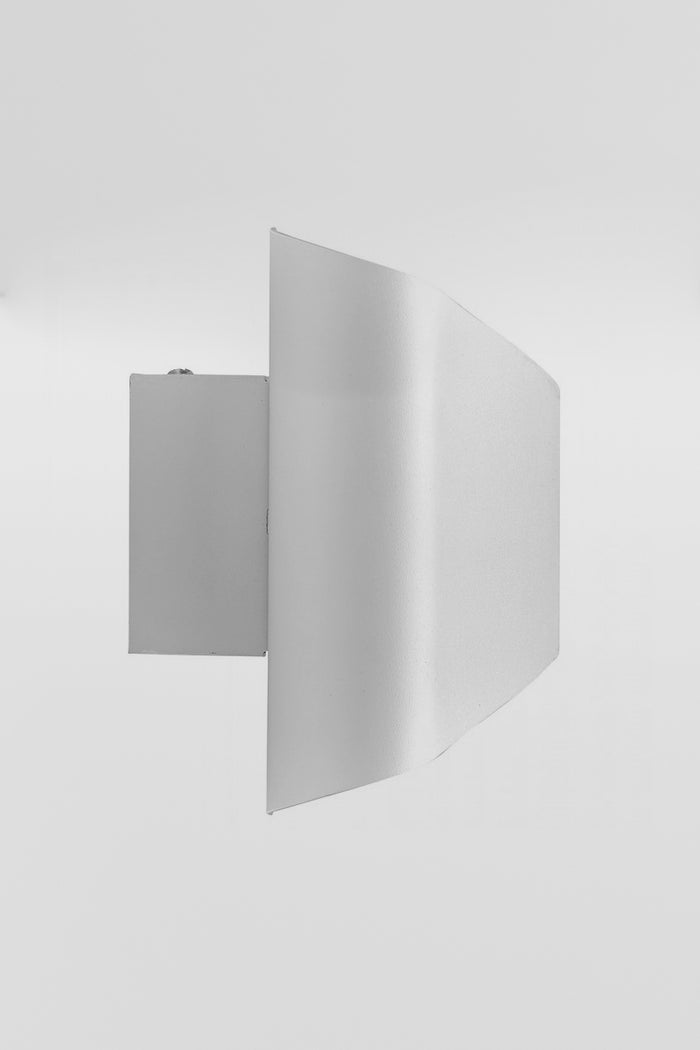 Sideview of the Up/Down wall light in a white finish with the light on.