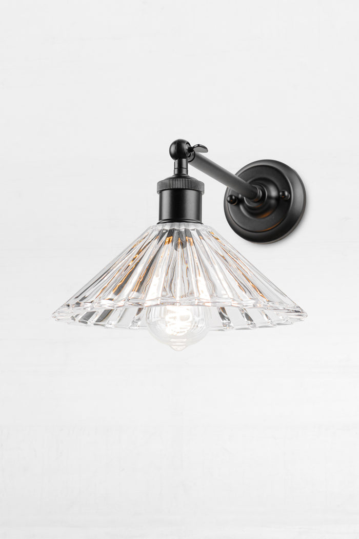 Black straight swivel arm sconce with a clear glass pleated shade.