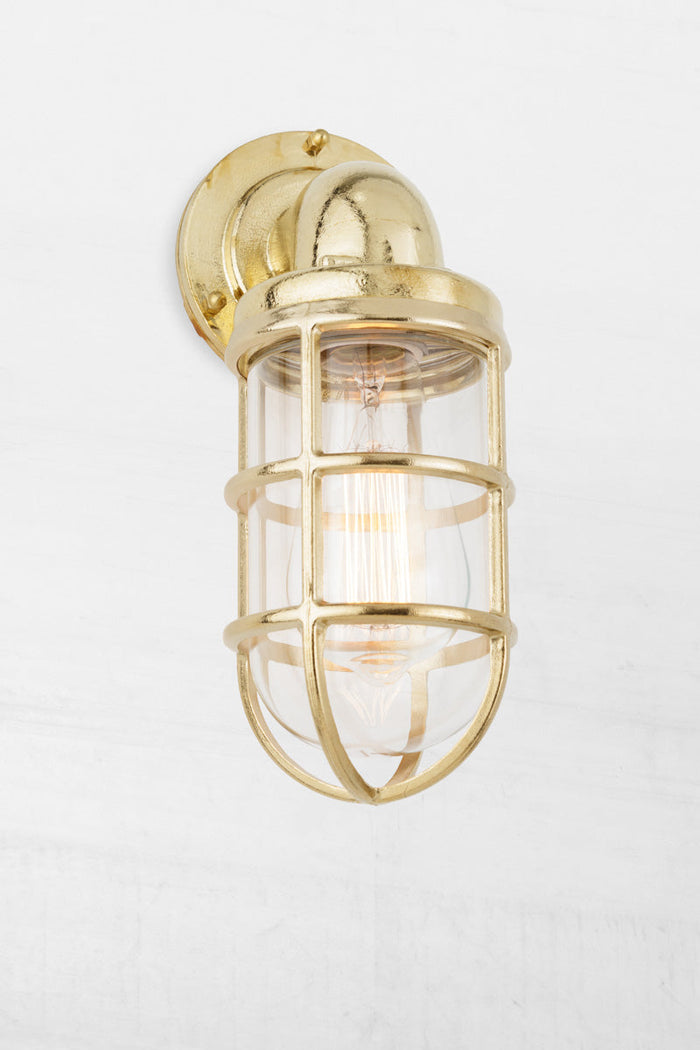 Side view of the solid brass marine style caged wall light.
