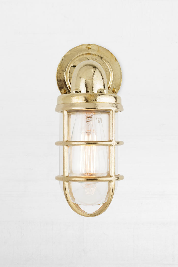 Front view of the solid brass marine style caged wall light.