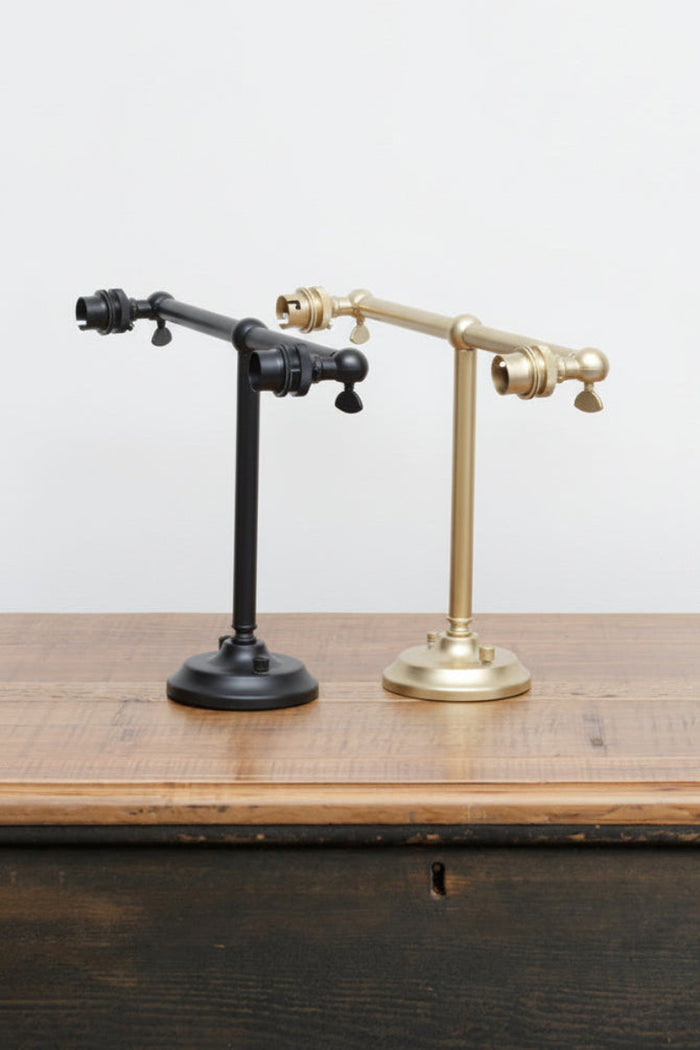 B22 double swivel steel wall sconce in black and gold/brass finishes.