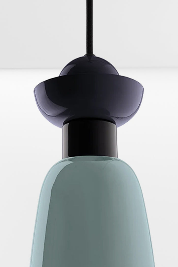 Close up detail of the Putnam Pendant Light Style A showing layered navy blue geometric detailing and glossy mist blue shade