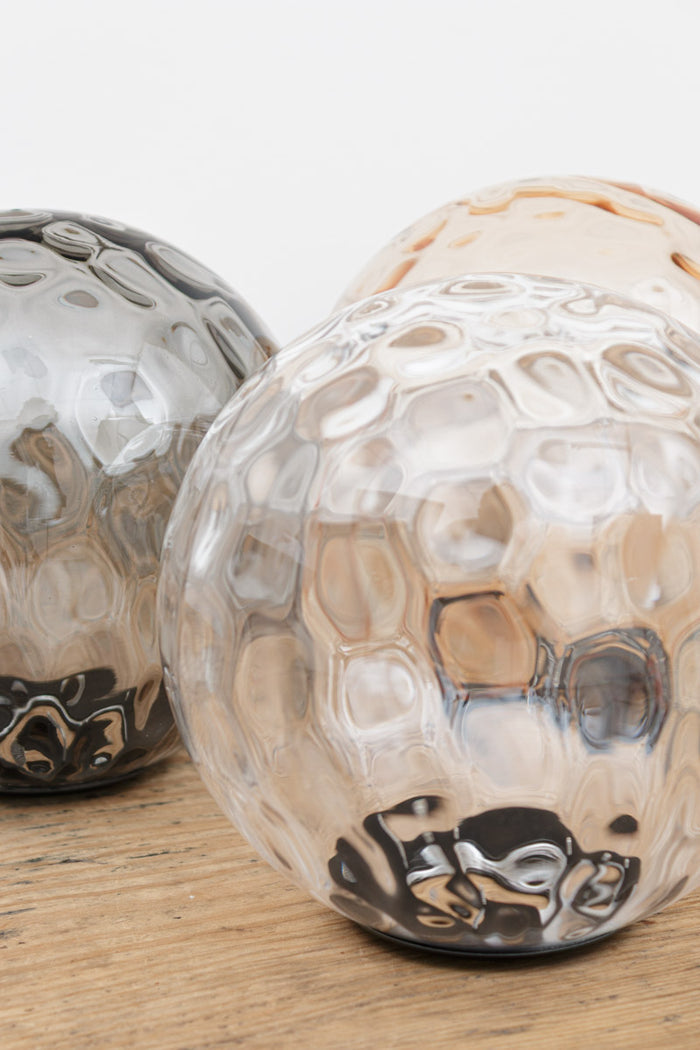 Close up of the dimpled glass shades in three finishes.