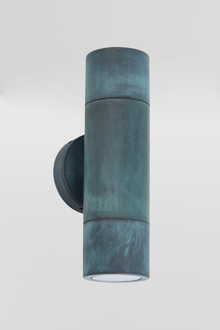 Solid brass up/down wall spot light with a patina green finish.