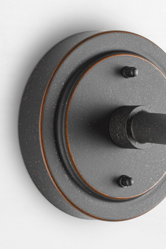 Close up of the wall mount of the antique bronze finishes wall light.