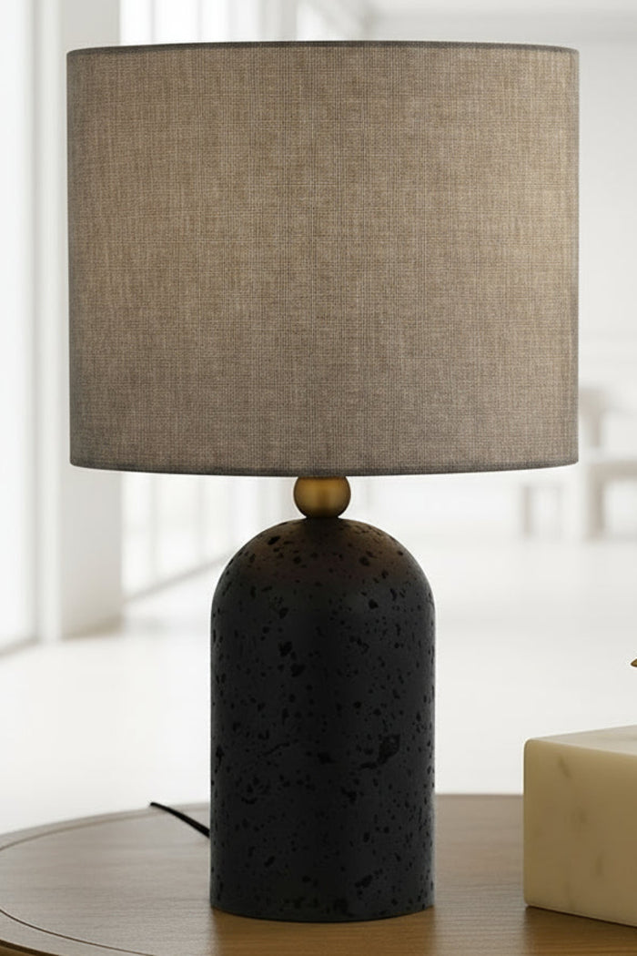Black table lamp with fabric shade.