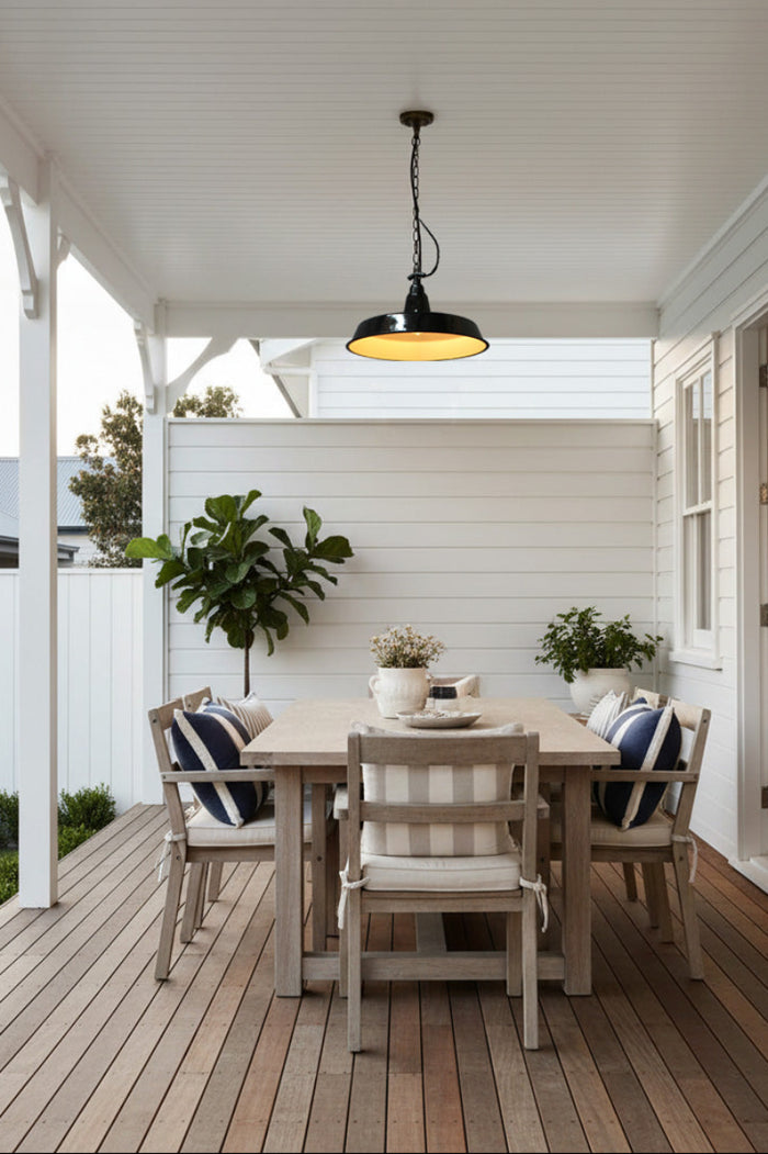 Black enamel pendant in white deck area over wooden table