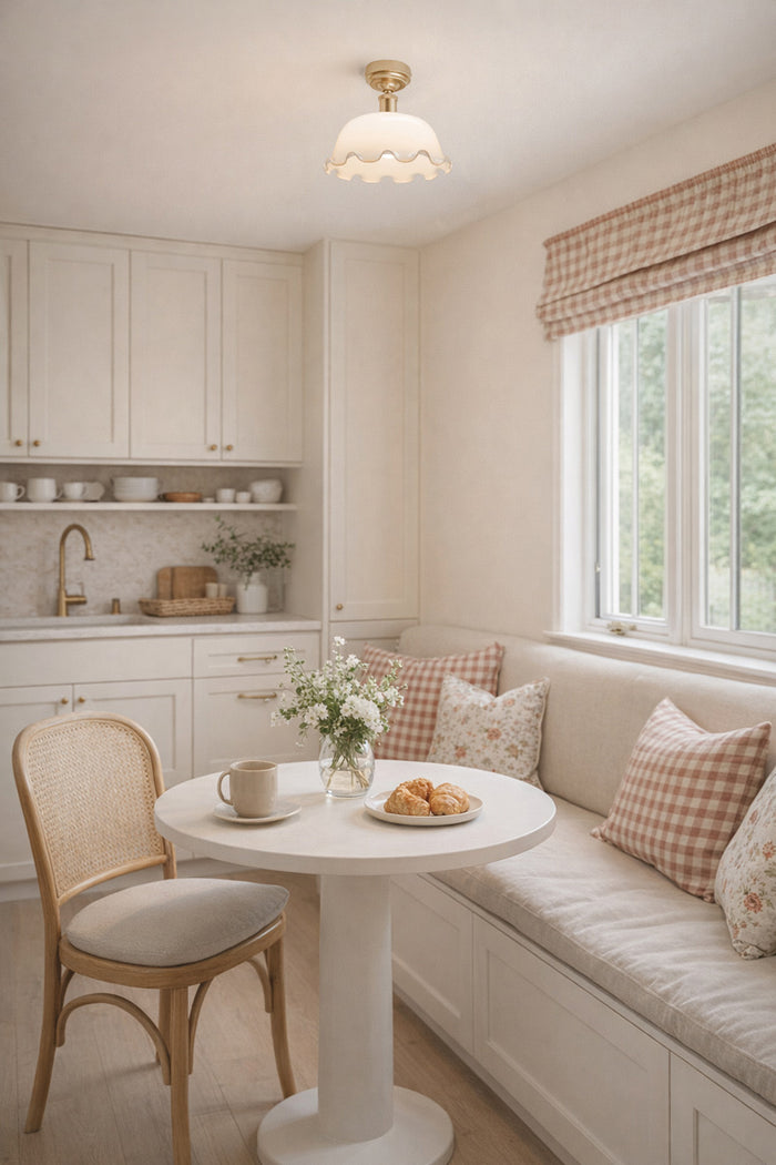 Opal glass shade with a frilled edge and gold/brass batten holder over a breakfast nook