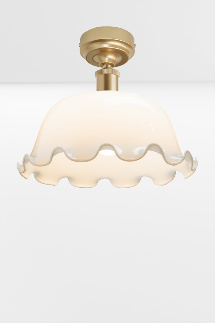 Gold/brass  batten older paired with an opal dome shade with frilled edging.