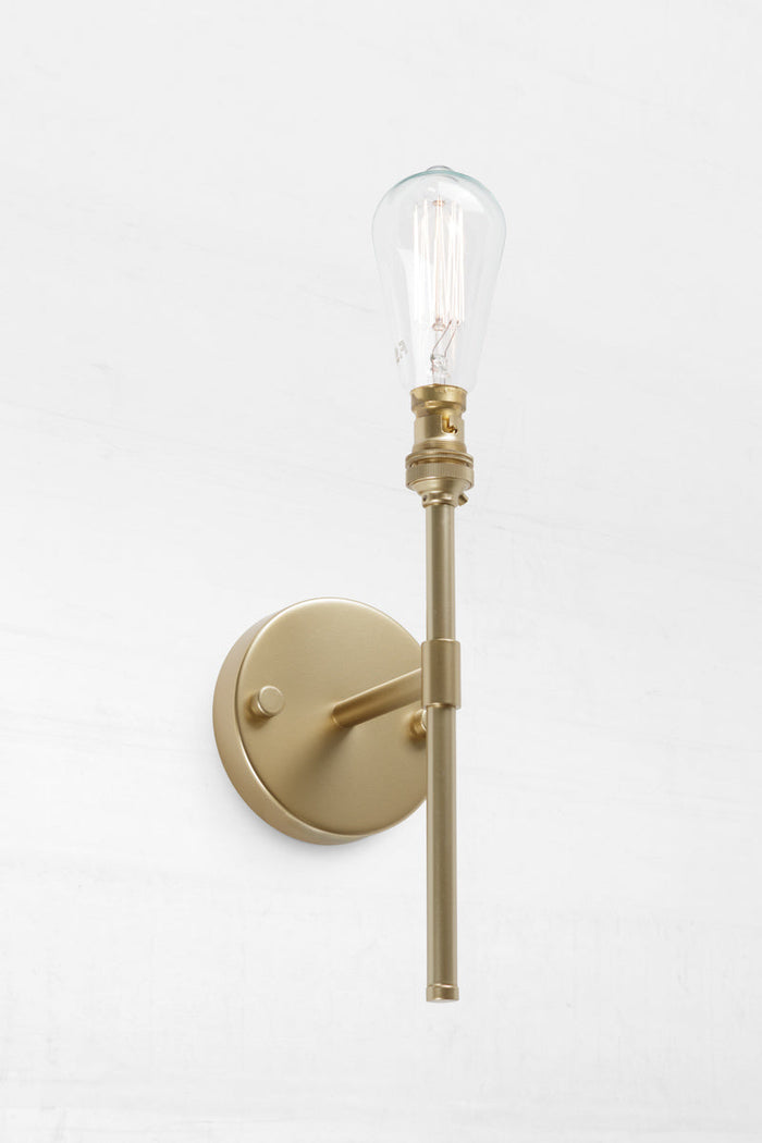 Gold finish on wall sconce makes it ideal for narrow wall placements