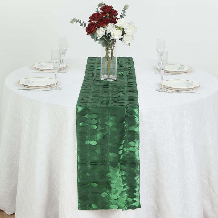 Green table runner on a white table with floral centerpiece and dining setup.