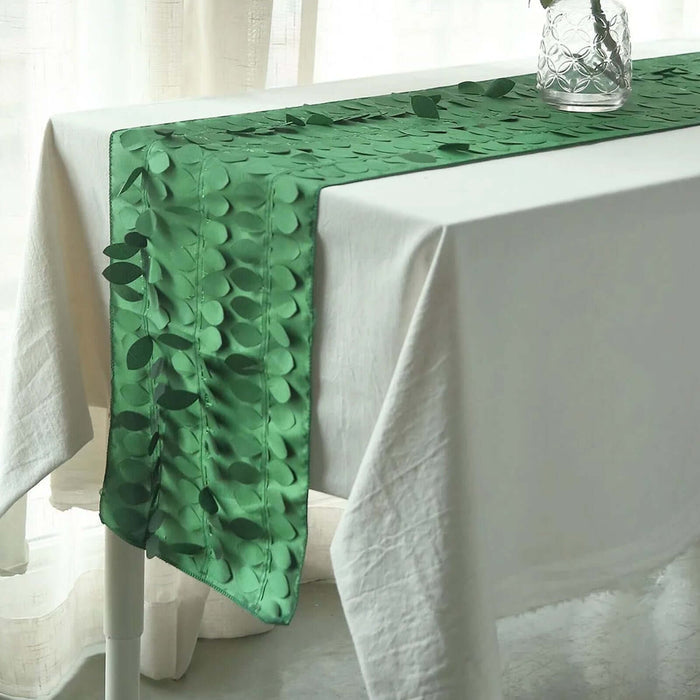 Green leaf-patterned table runner on a white tablecloth