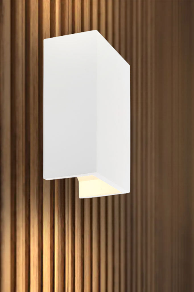 Rectangular plaster wall light mounted on timber batten lined wall.