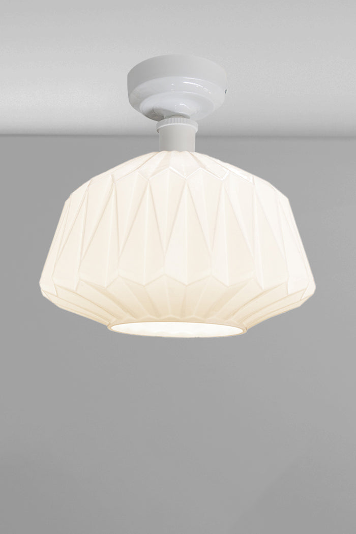Large geometrically detailed opal shade paired with a white batten holder.