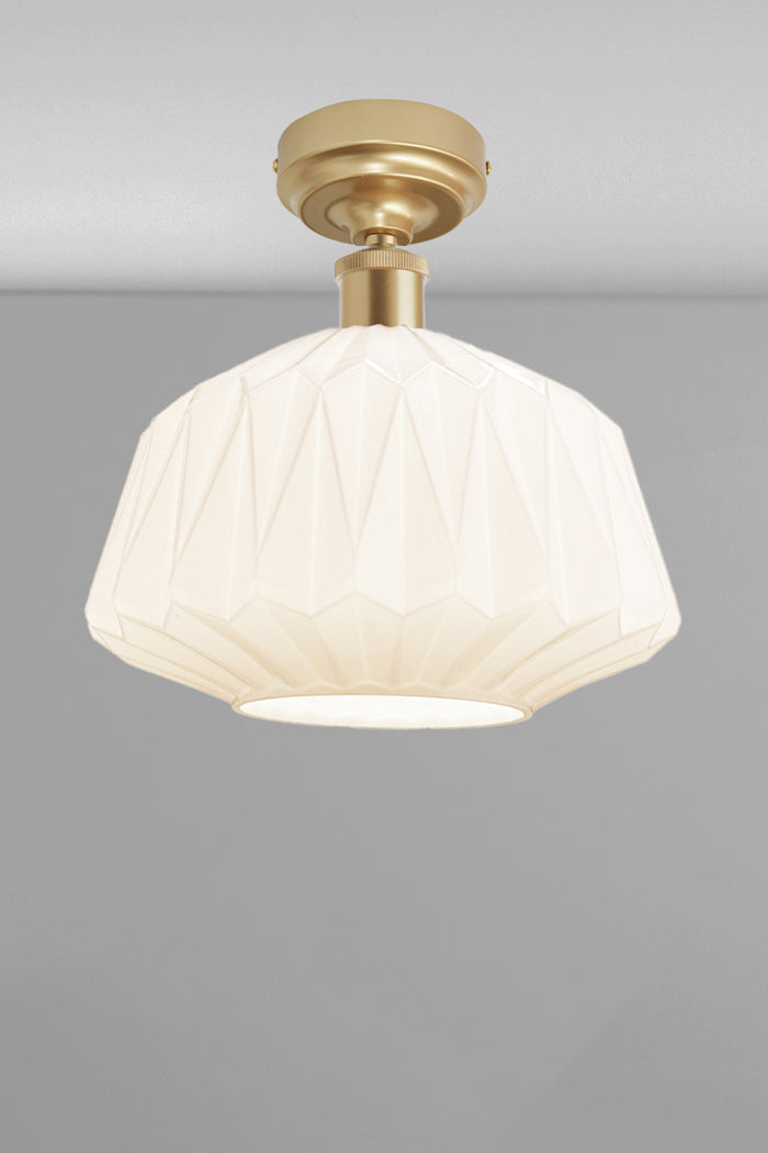 Large geometrically detailed opal shade paired with a gold/brass batten holder.