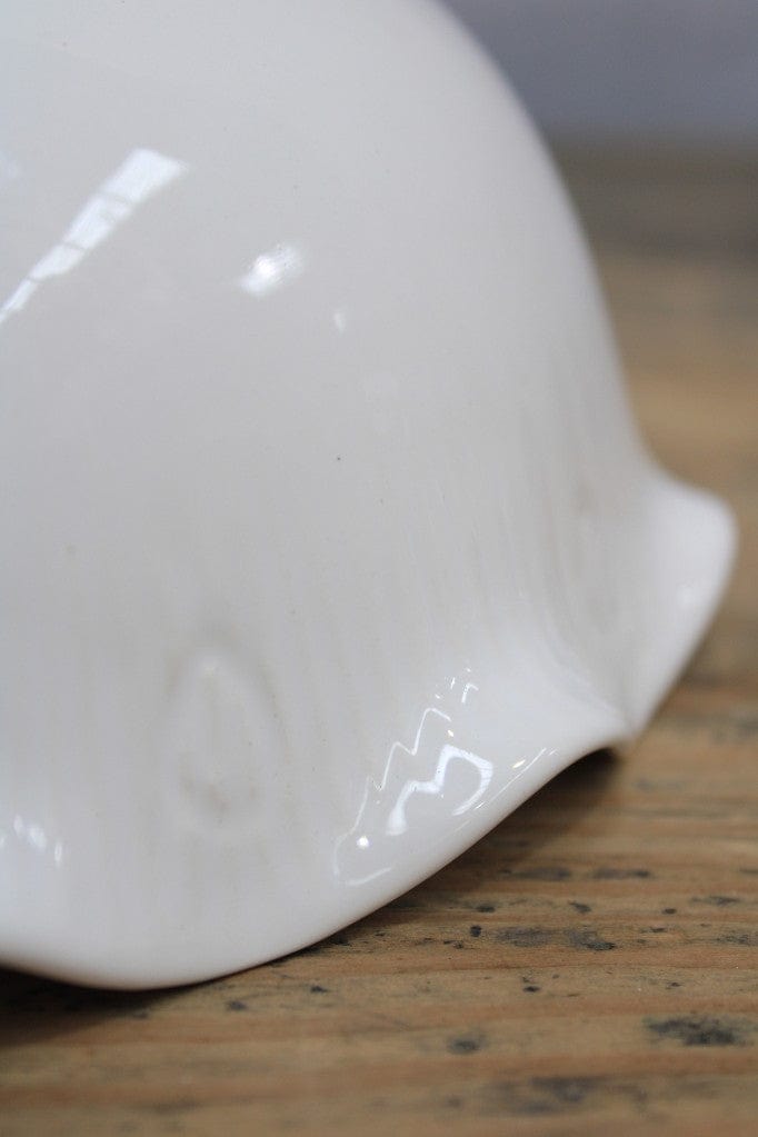 Close-up of ripple detailing on ceramic shade.