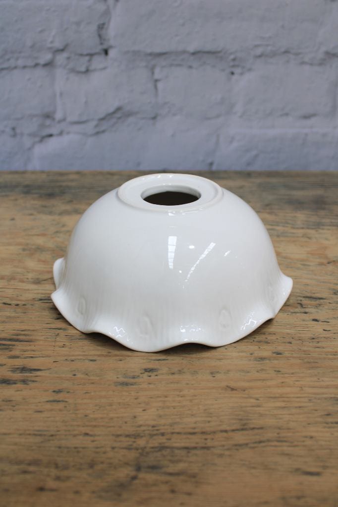Ceramic shade on wooden surface.