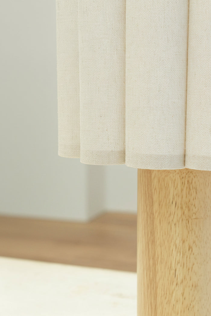 Close up of the scalloped detailing on the fabric shade and top of the timber base.