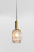 Close up of the Amber reeded glass shade with antique brass metalware.