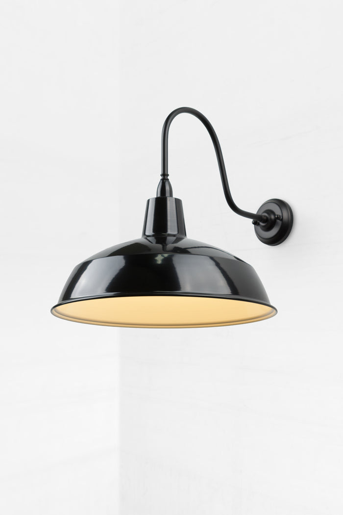 Black steel shade on an extra large black gooseneck outdoor wall sconce.