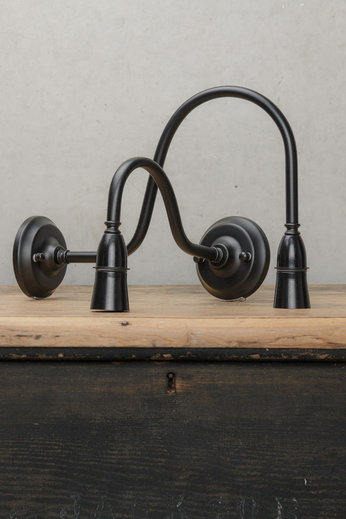 Two gooseneck wall sconces in black steel