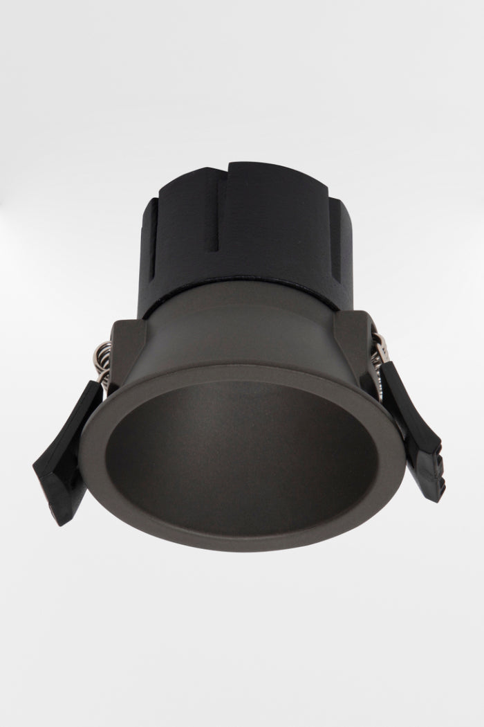 Black LED downlight, showing side clamps.