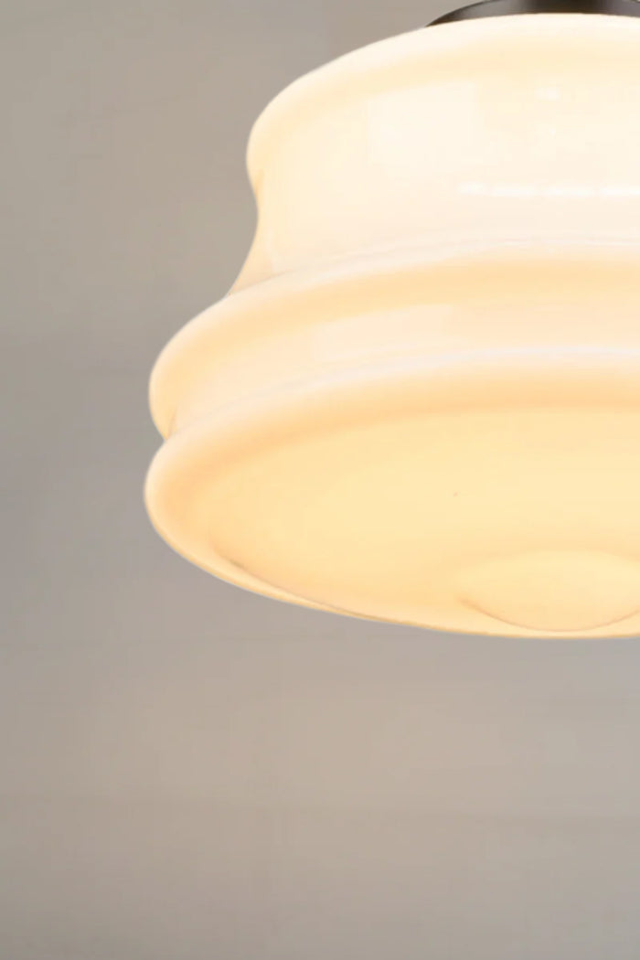 Classic opal glass light shade paired with a black pendant cord for versatile styling.