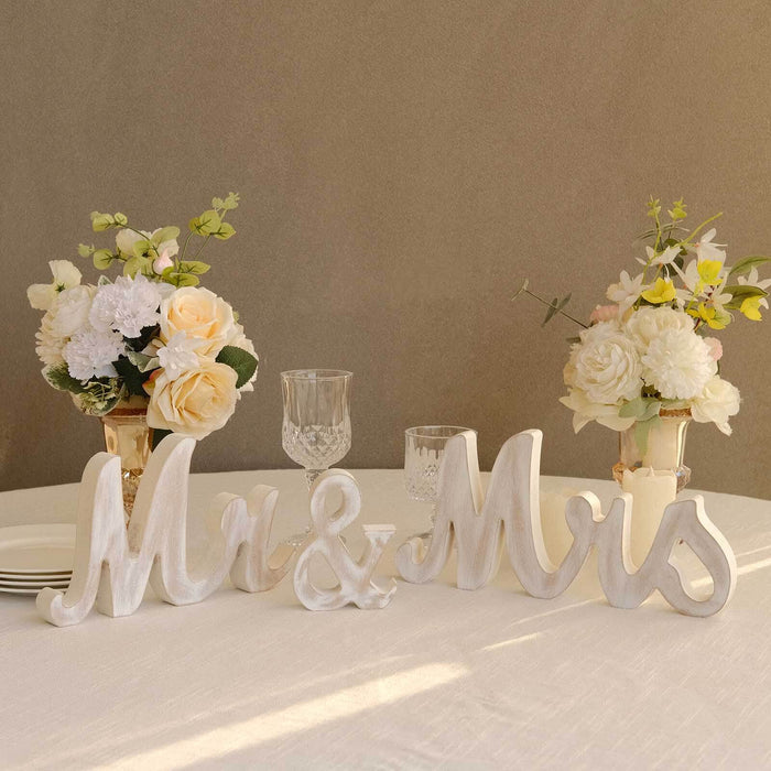 "Decorative Mr & Mrs letters with floral arrangements on a table setting"